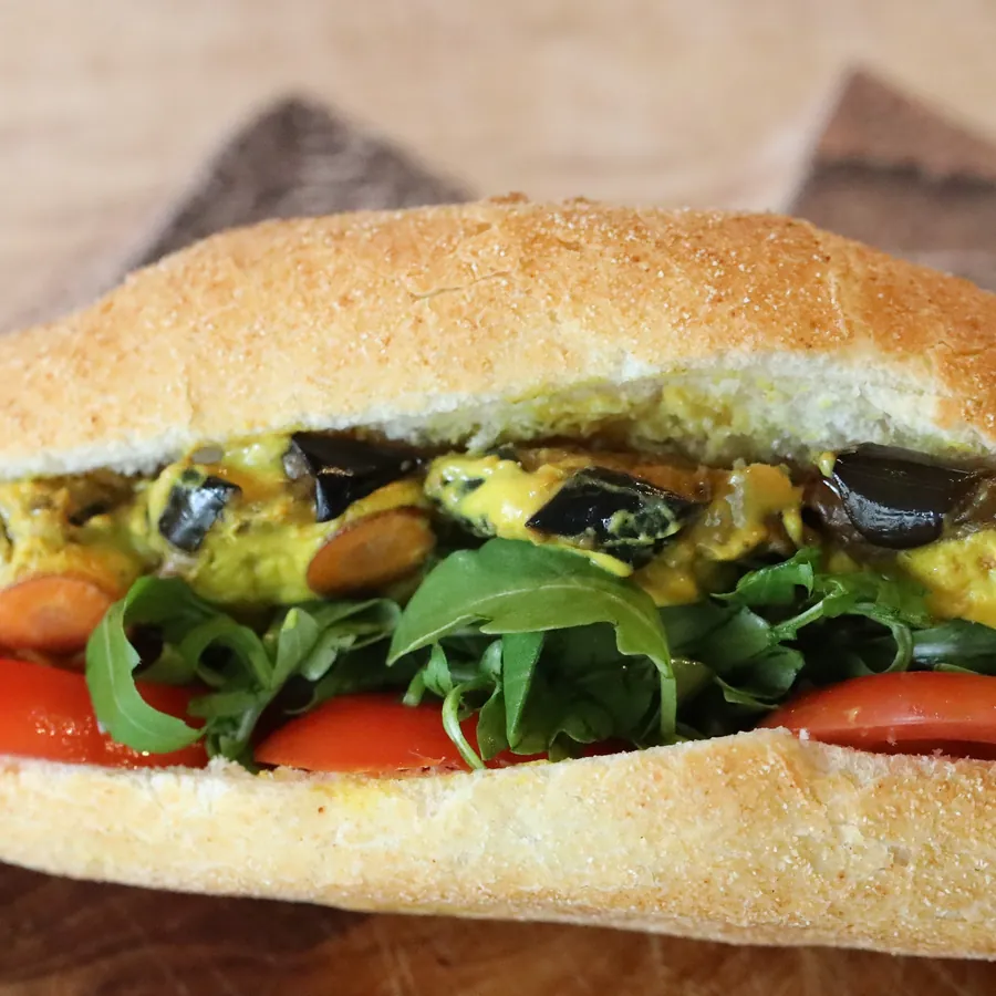 A golden sub packed with roasted aubergine, olives and rocket