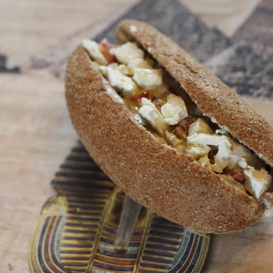 A wholemeal roll with fava beans, feta and rocket