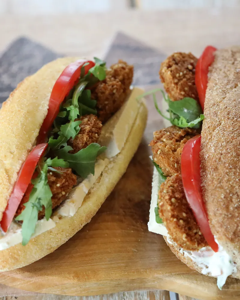 A layered falafel roll with tomato and rocket