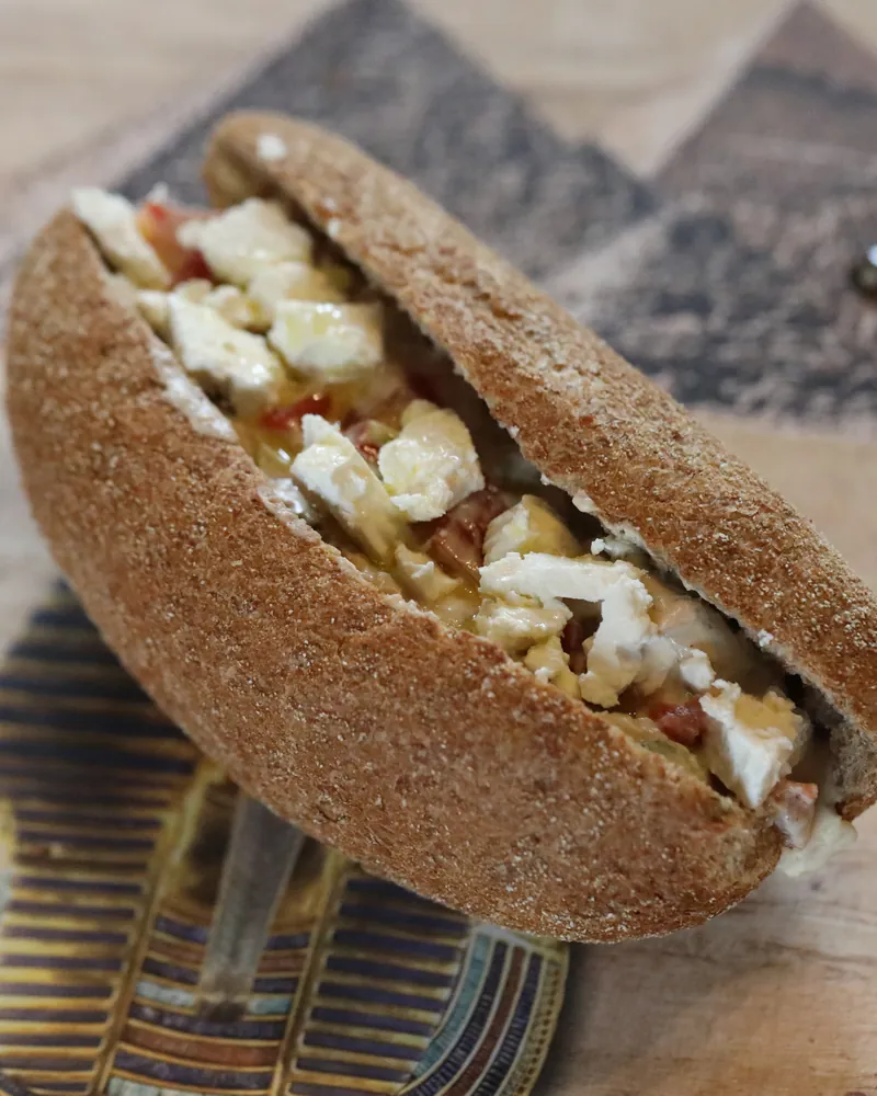 A pitta of spiced potato and cheese with fresh leaves