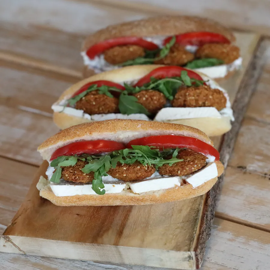 A falafel sandwich with tomato and soft cheese