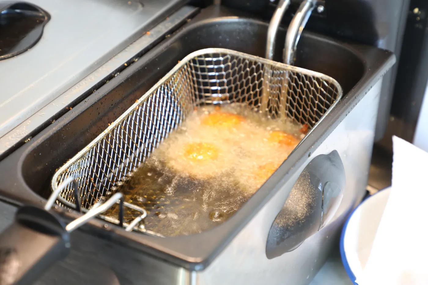Falafel frying to a deep gold in the kitchen