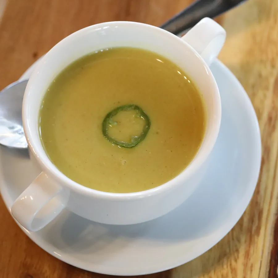 Lentil soup served in a white cup and saucer