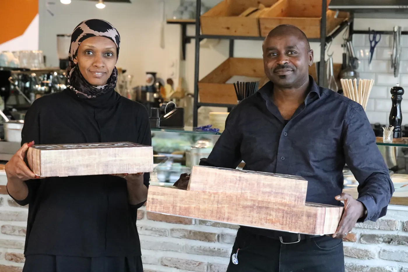 Two members of the Napata team carrying catering boxes