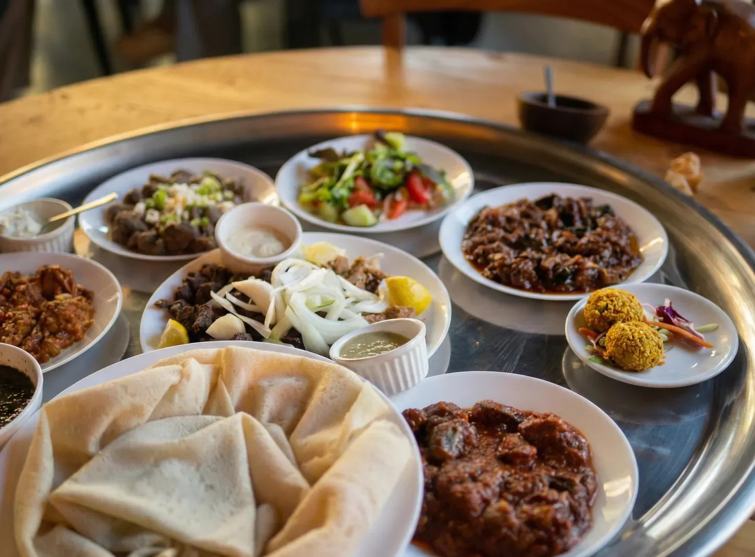 Sudanese dinner platter with grilled shayia, stews and breads